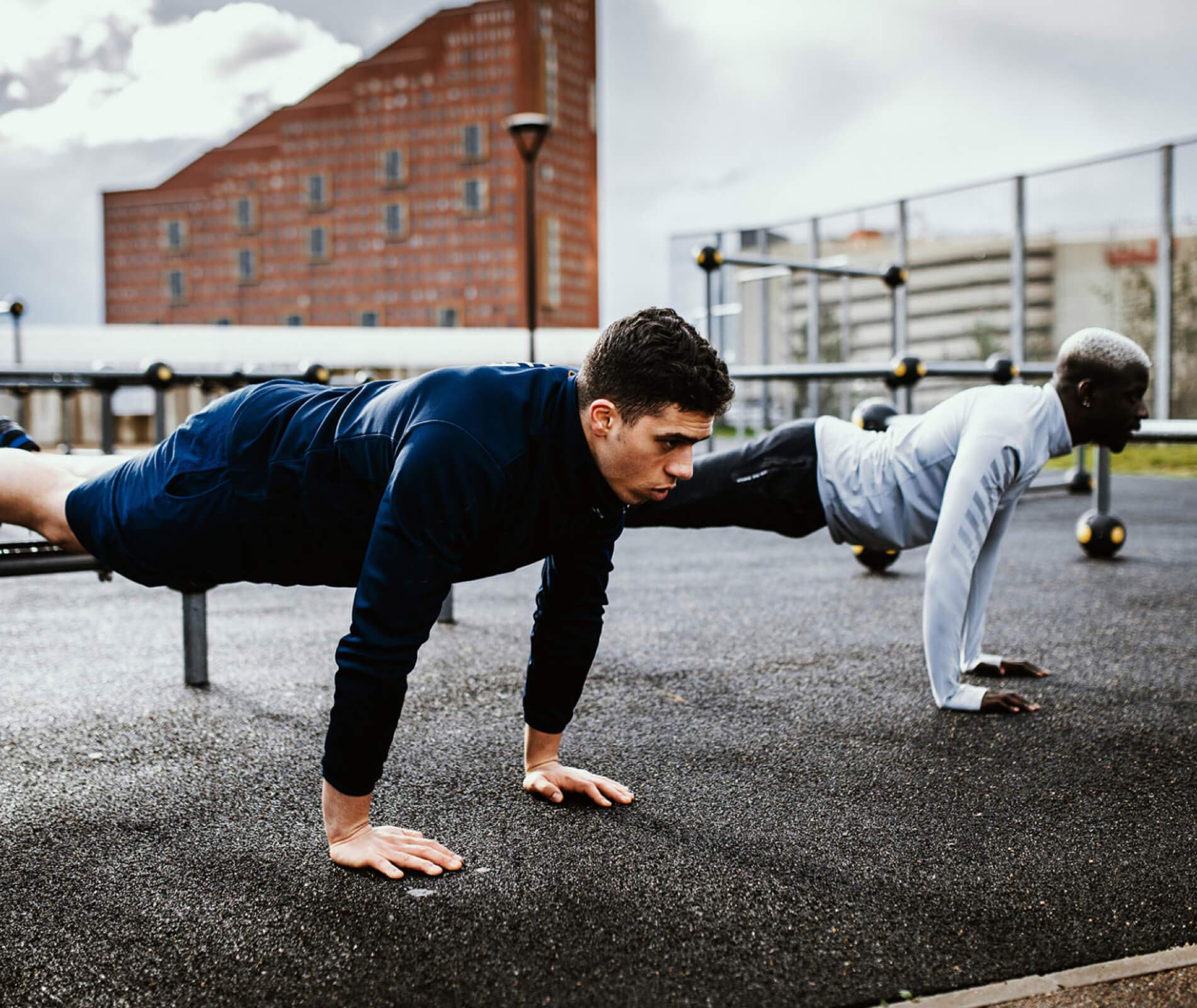 Men doing push-ups outside